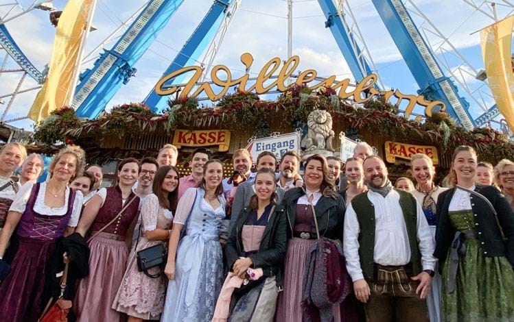 Large group in front of a ferris wheel