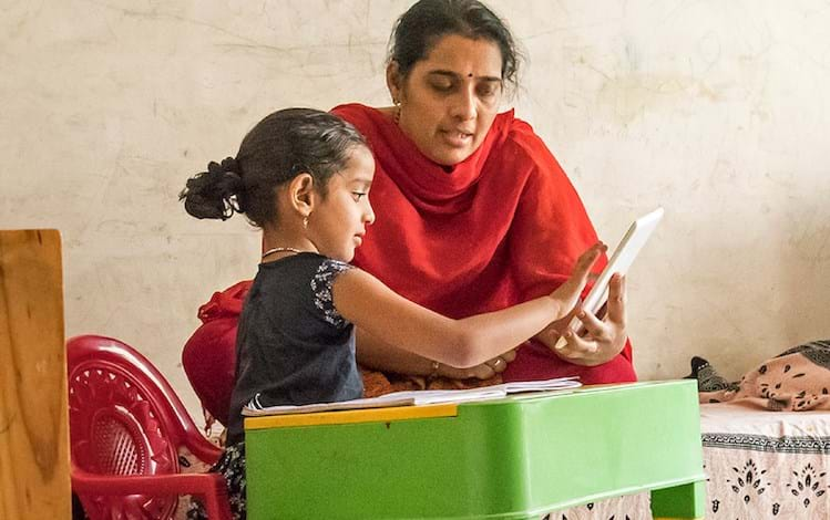 Woman and young girl at table - India's development sector adapting to the new ecosystem whitepaper