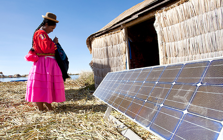 women using solar panels in field