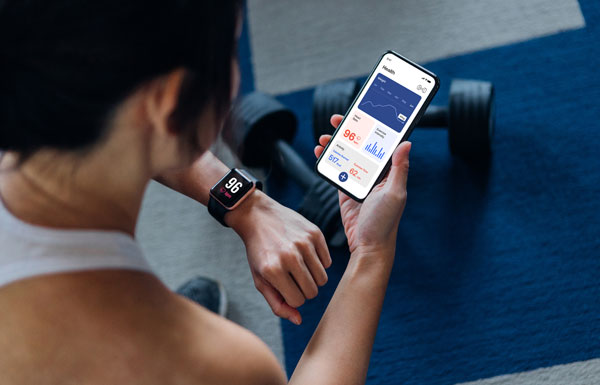 woman tracking fitness with watch and phone