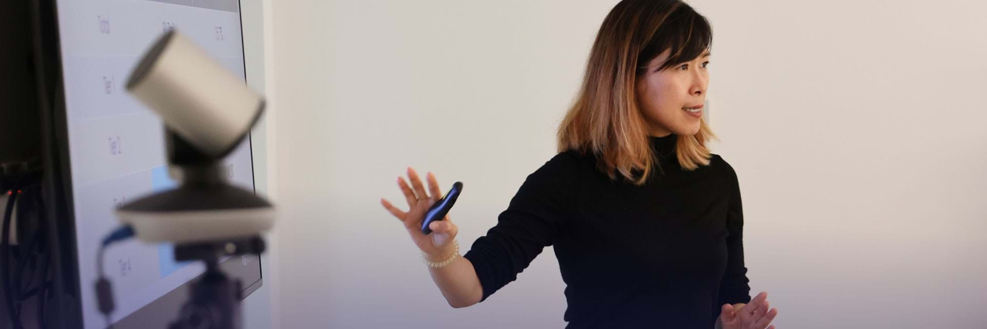 Woman gesturing at TV screen