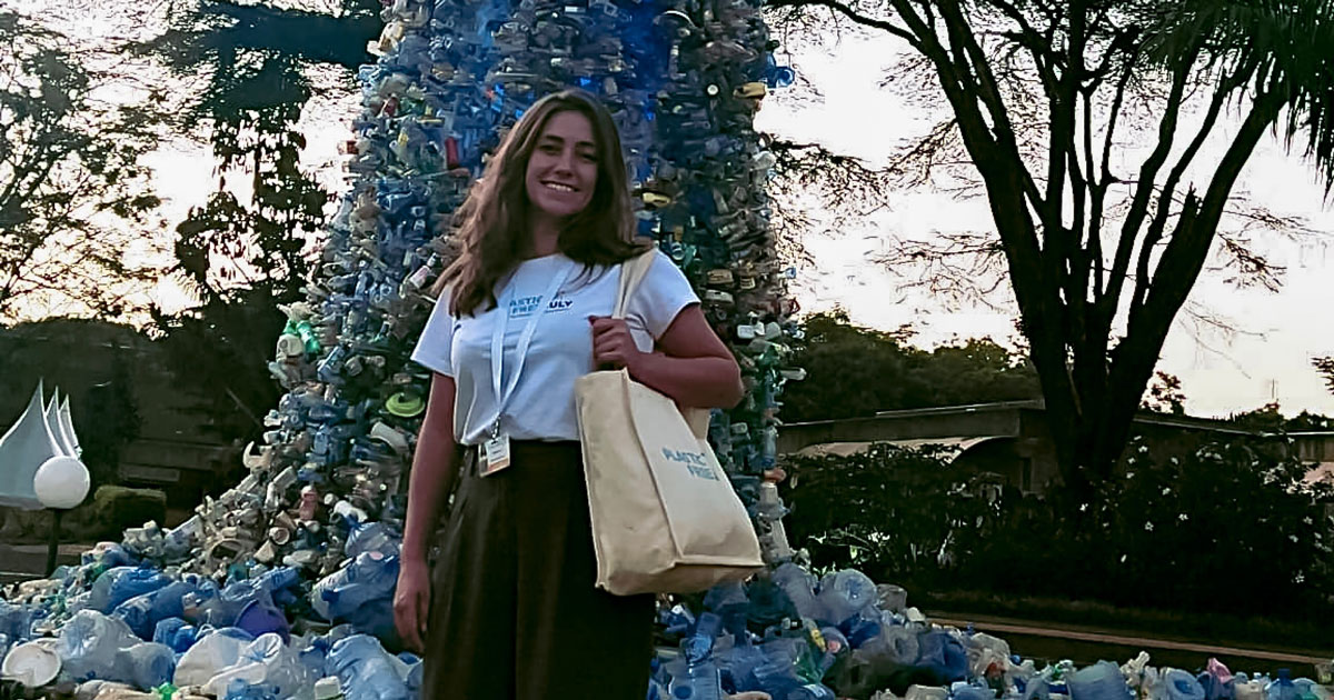 woman in front of plastic statue