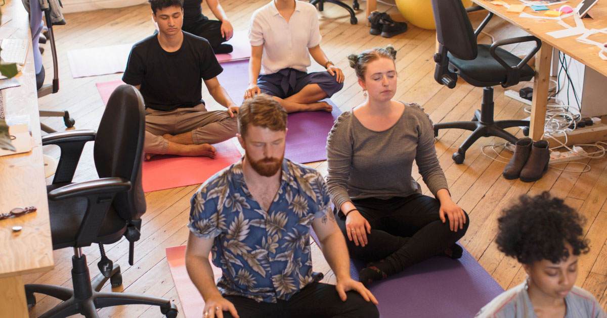 Business people meditating in office